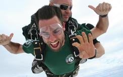 Adam Greenberg skydiving in AmeriCorps NCCC Team Leader shirt
